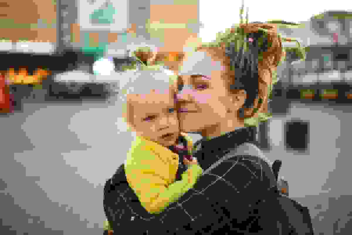 Nainen pikkutyttö sylissä