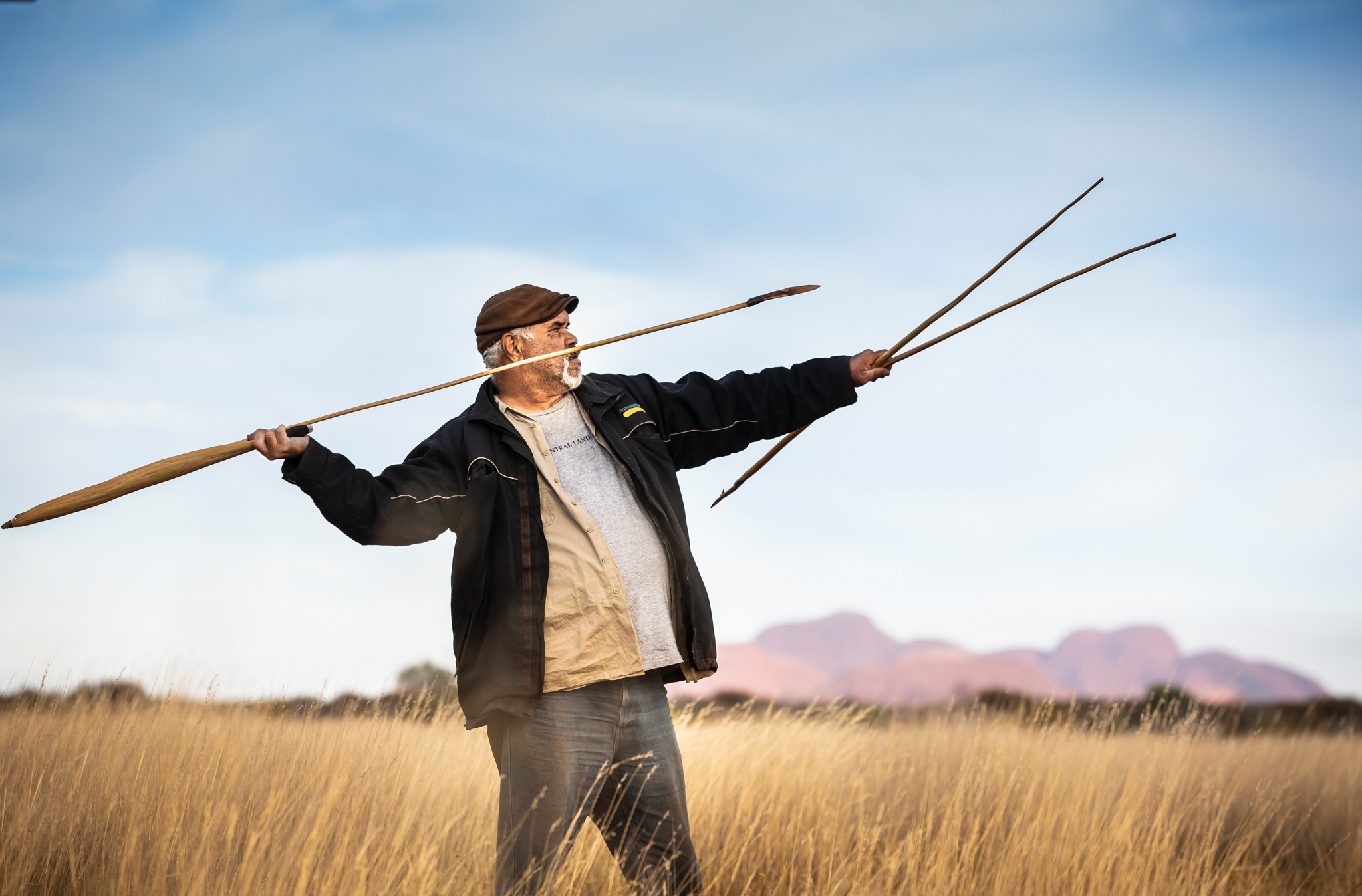 SEIT Australia’s Patji tour guide, Sammy Wilson, throwing a spear in Uluru, NT © Tourism Australia 