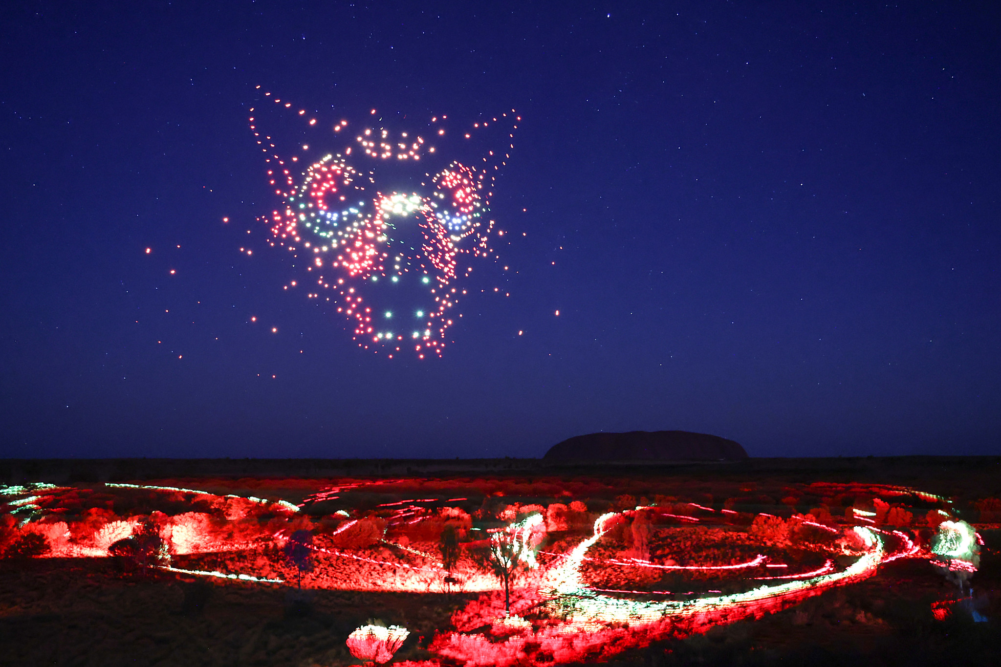 The Wintjiri Wiru drone and laser show lights up the night sky around Uluru, Northern Territory © Voyages Indigenous Tourism Australia