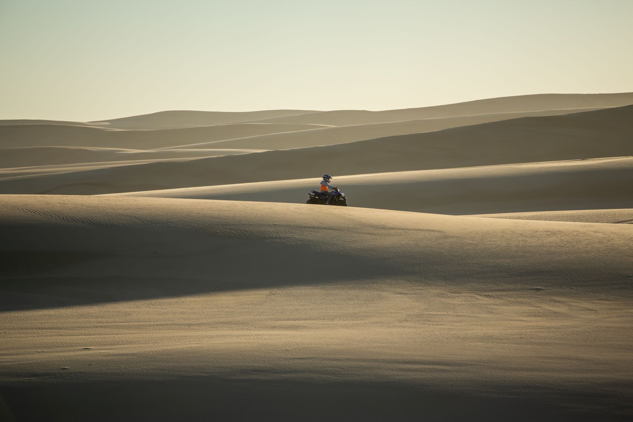 Taking in the spiritual sand dunes around Port Stephens on a quad bike with Sand Dune Adventures, NSW© Tourism Australia