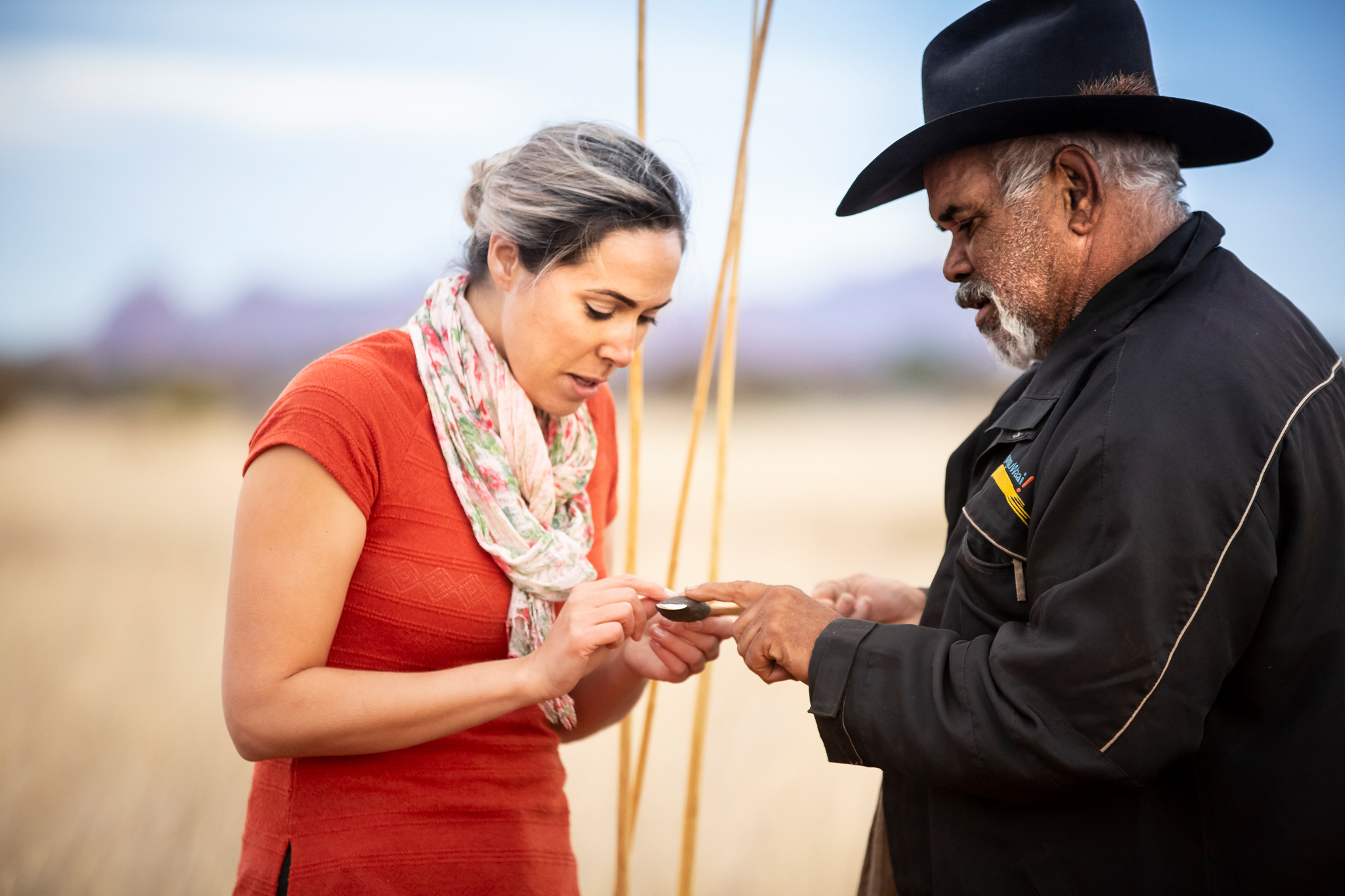 SEIT Outback Australia tour guide explaining the use of a spear to a guest in Uluru, NT © Tourism Australia