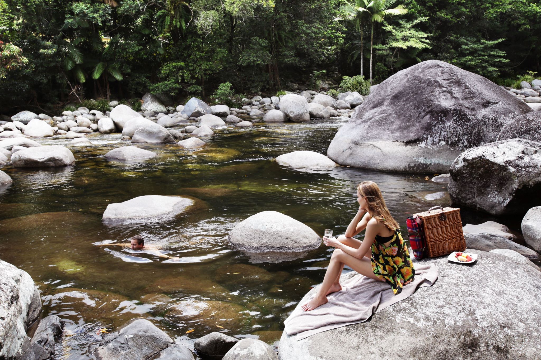 Woman enjoying the scenery around a waterhole at Mossman Gorge © Tourism Australia