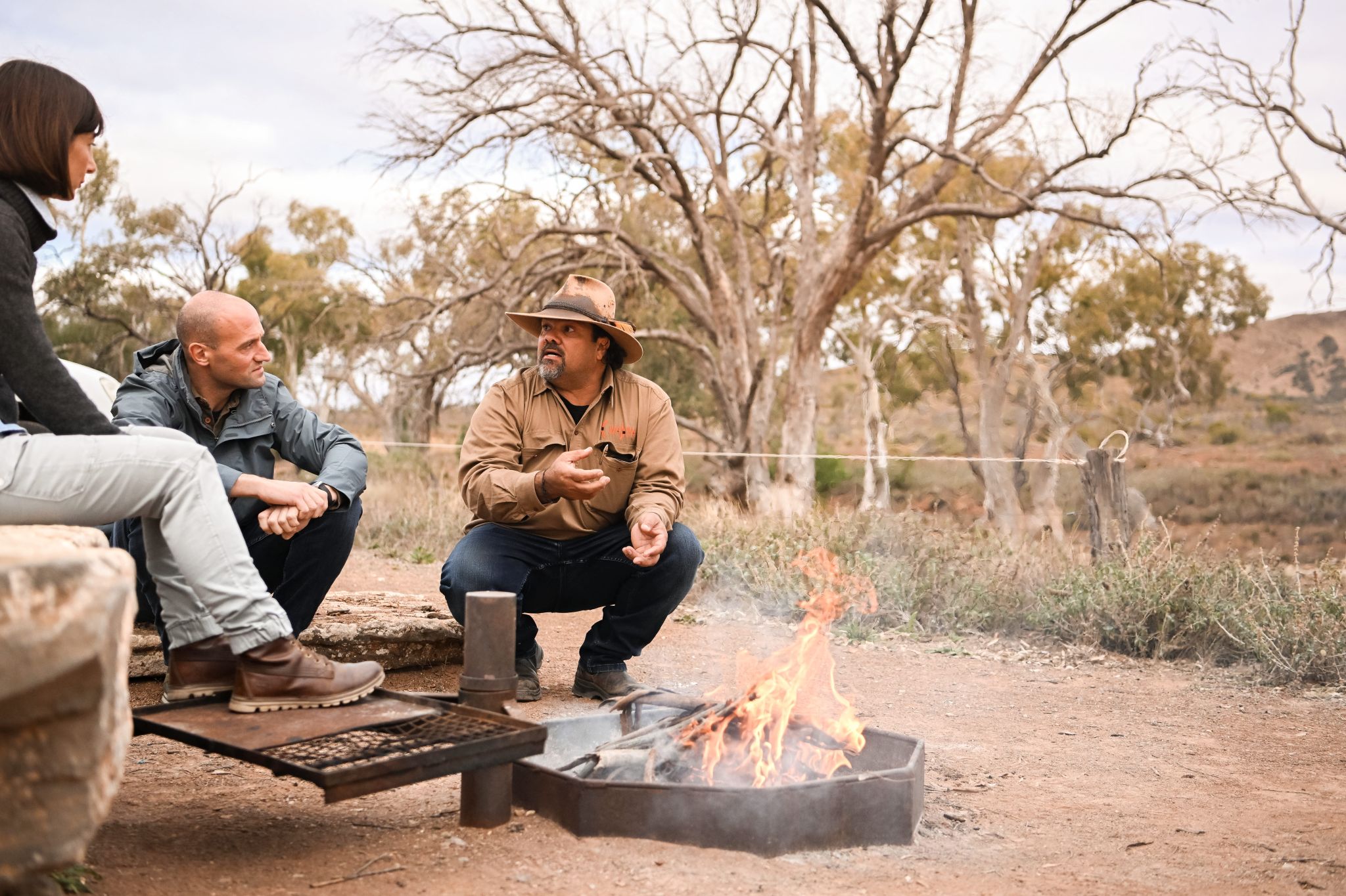 Guide Kristian Coulthard of Wadna beside a fire in the Ikara-Flinders Ranges region of South Australia © Tourism Australia