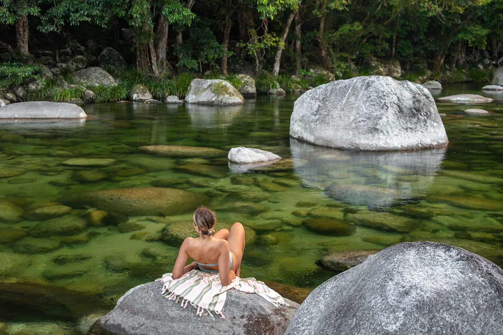 Relaxing by a waterhole at Mossman Gorge © Tourism Australia