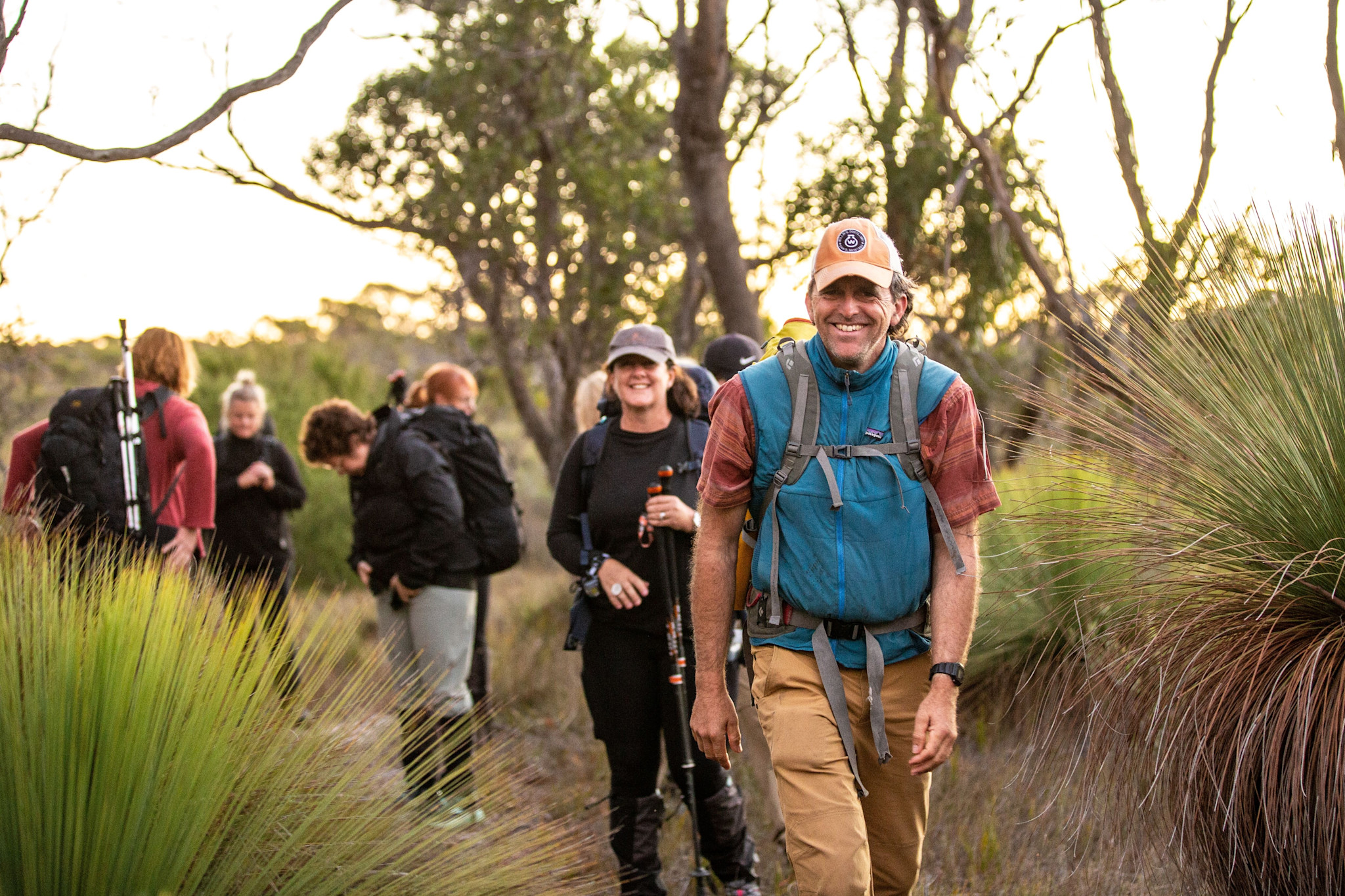 Hiking through remote bushland along Tasmania’s east coast at sunset with Wukalina Walk © Tourism Australia