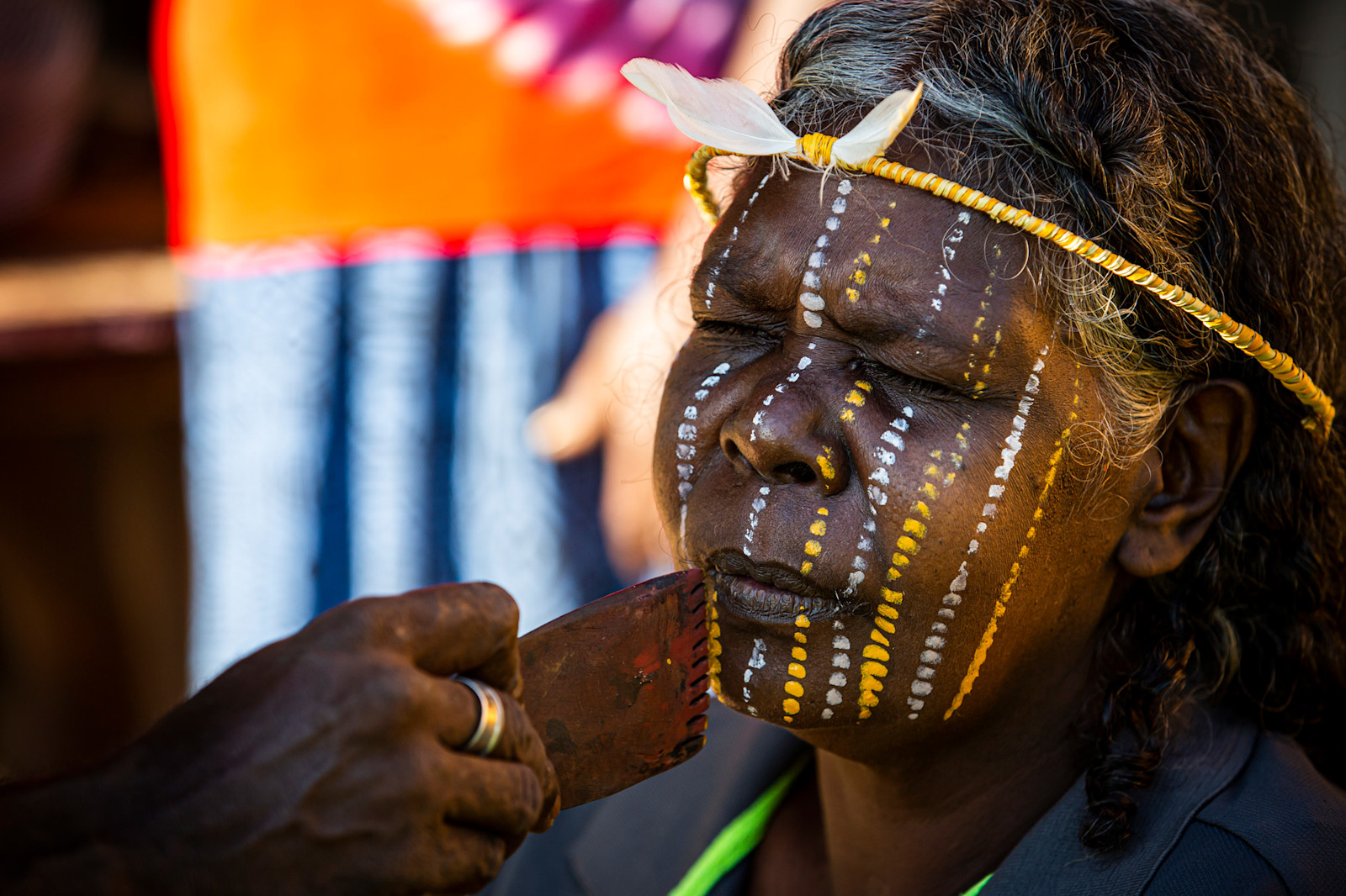 A Tiwi Islander getting her face painted for a ceremony, NT © Tourism Australia 