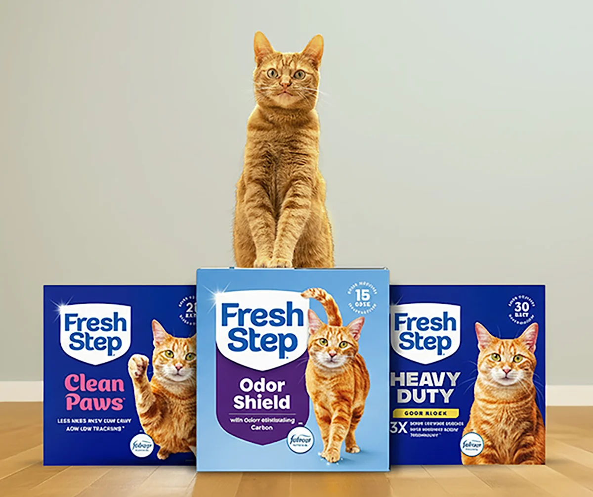 Fresh Step™ Family Shot including Clean Paws, Odor Shield and Heavy Duty cat litter with an orange cat on top
