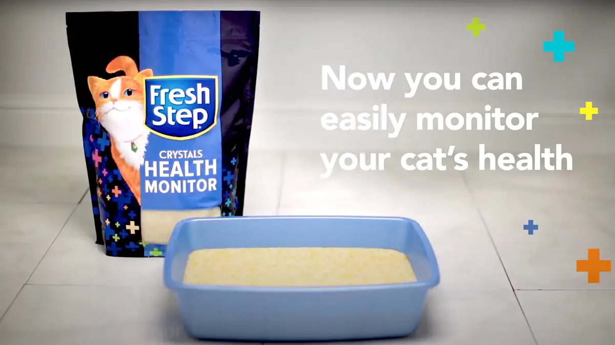 Tile floor with litter box and Fresh Step Crystals Health Monitor and the words "Now you can easily monitor your cat's health"