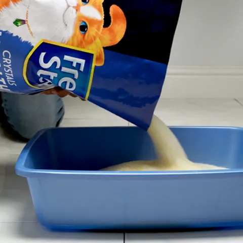 lightweight crystals being poured into a litter box