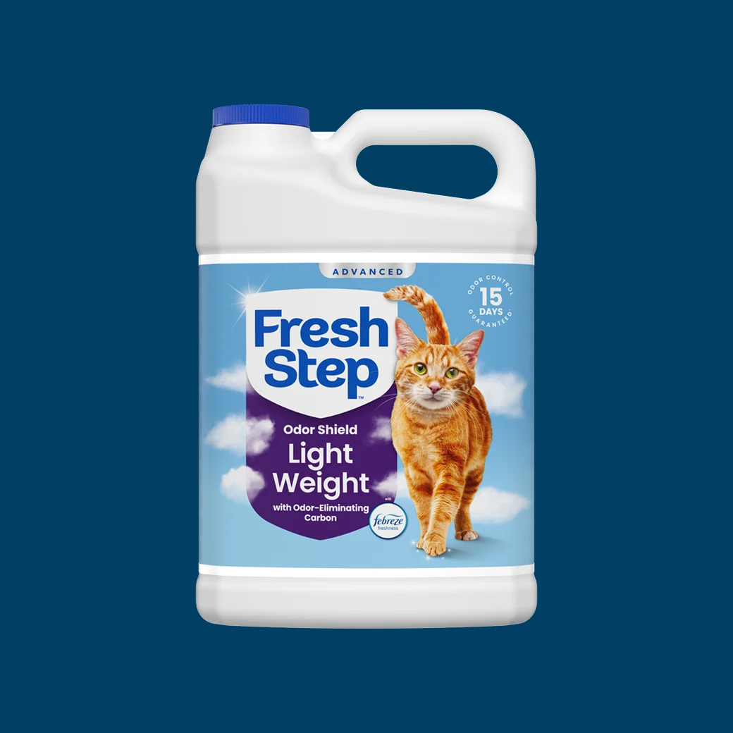 A plastic jug of Fresh Step Lightweight Odor Shield Advanced on a blue background