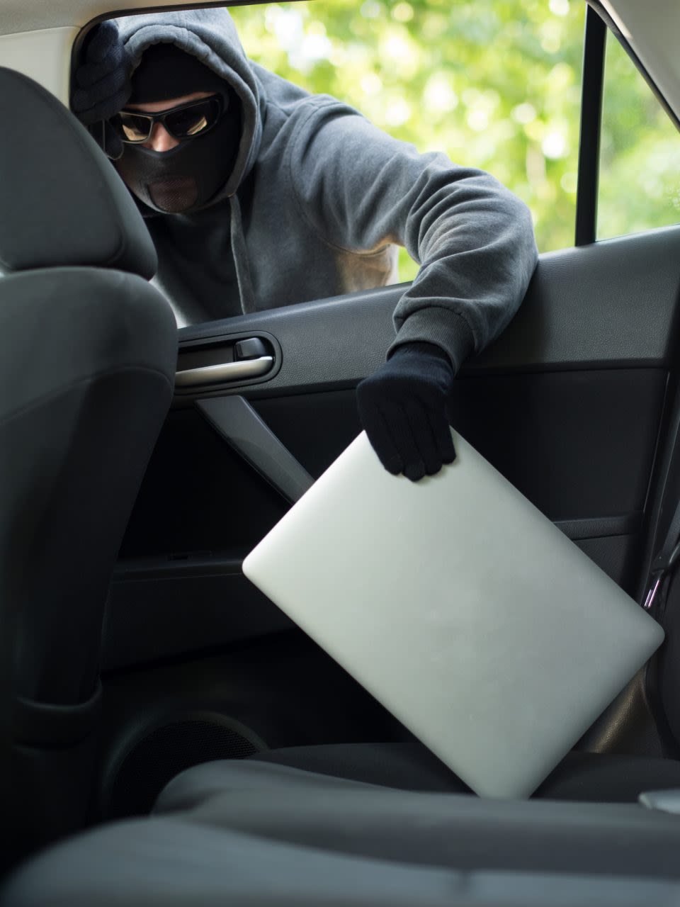Someone stealing a laptop
