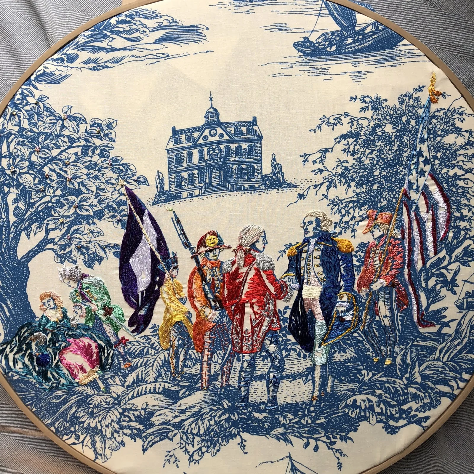 Richard Saja, a textile artist from New York, likes to have fun with traditional French fabrics called “toile”. He adds clowns, punk rockers and werewolves to the classic designs by embroidering them. This creates his own special style. His art brings humor and playfulness to the peaceful scenes of this old-fashioned fabric.