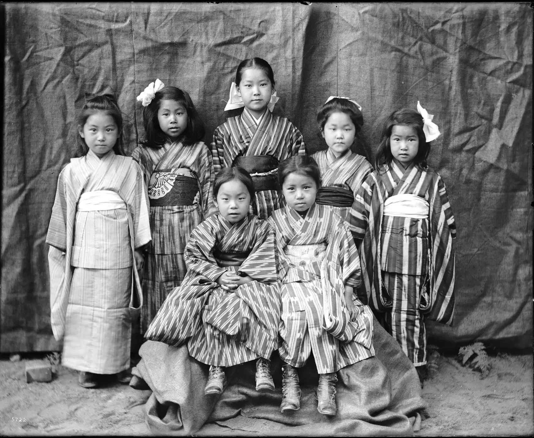 Japan 1900: These seven young Japanese girls from a missionary school wore colorful silk kimonos and fancy hairstyles. During the Meiji period (1868–1912), girls in Japan started going to school as the education system became more modern. Do you think it was easy for them to move and play in their kimonos?