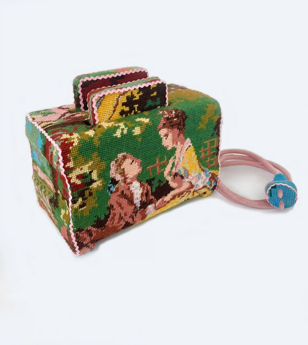 The history of embroidery is closely tied to homes and families. Swedish artist Ulla Stina Wikander uses cross-stitch to transform old household objects like toasters and coffee machines into sculptures, adding a bit of humor. Can you tell what this used to be?