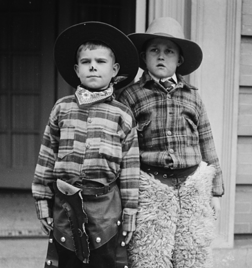 Two boys dressed as cowboys.