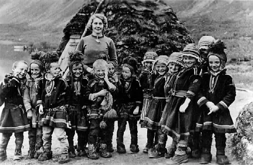 Sweden, 1950s: The Sami are a nomadic people living in northern Norway, Finland, Sweden, and Russia. In the 1840s, schools tried to make them more like others in those places. But in the 1900s, Sami children began learning in their own Sami language. Sami kids wear a gákti – a colorful tunic with bright patterns – leggings, and reindeer-hide shoes.