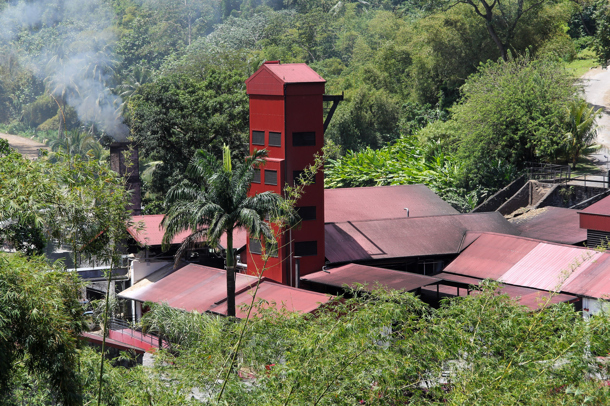 red building amidst a tropical landscape