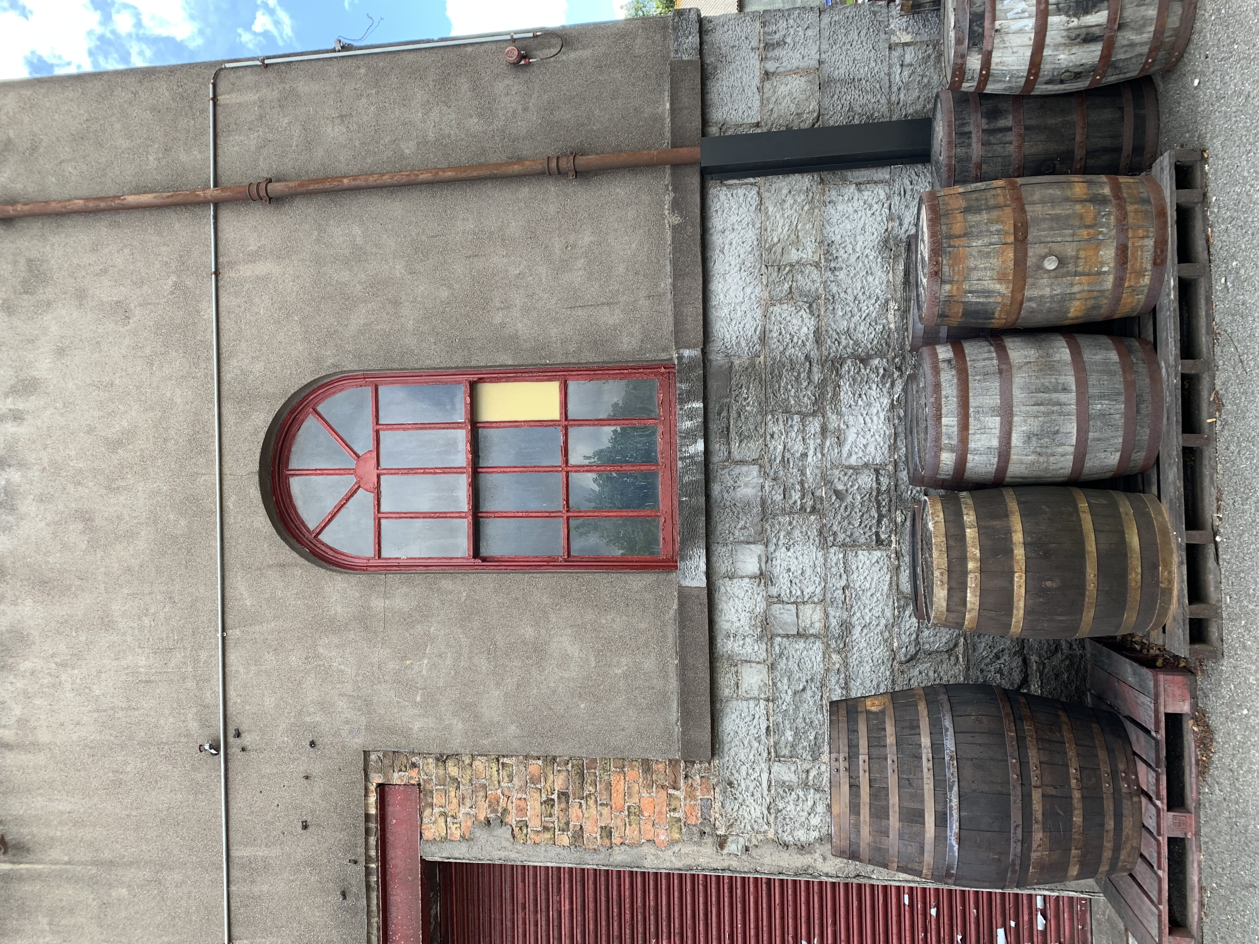 Types of Barrels on pallets next to a building