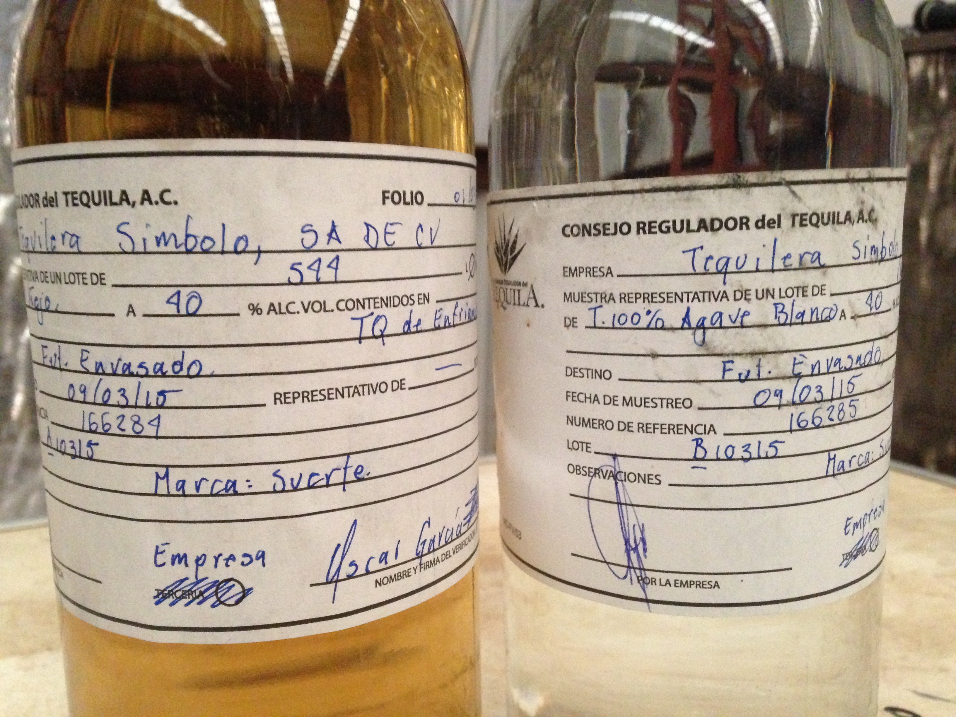 an official, handwritten label over two tequila bottles