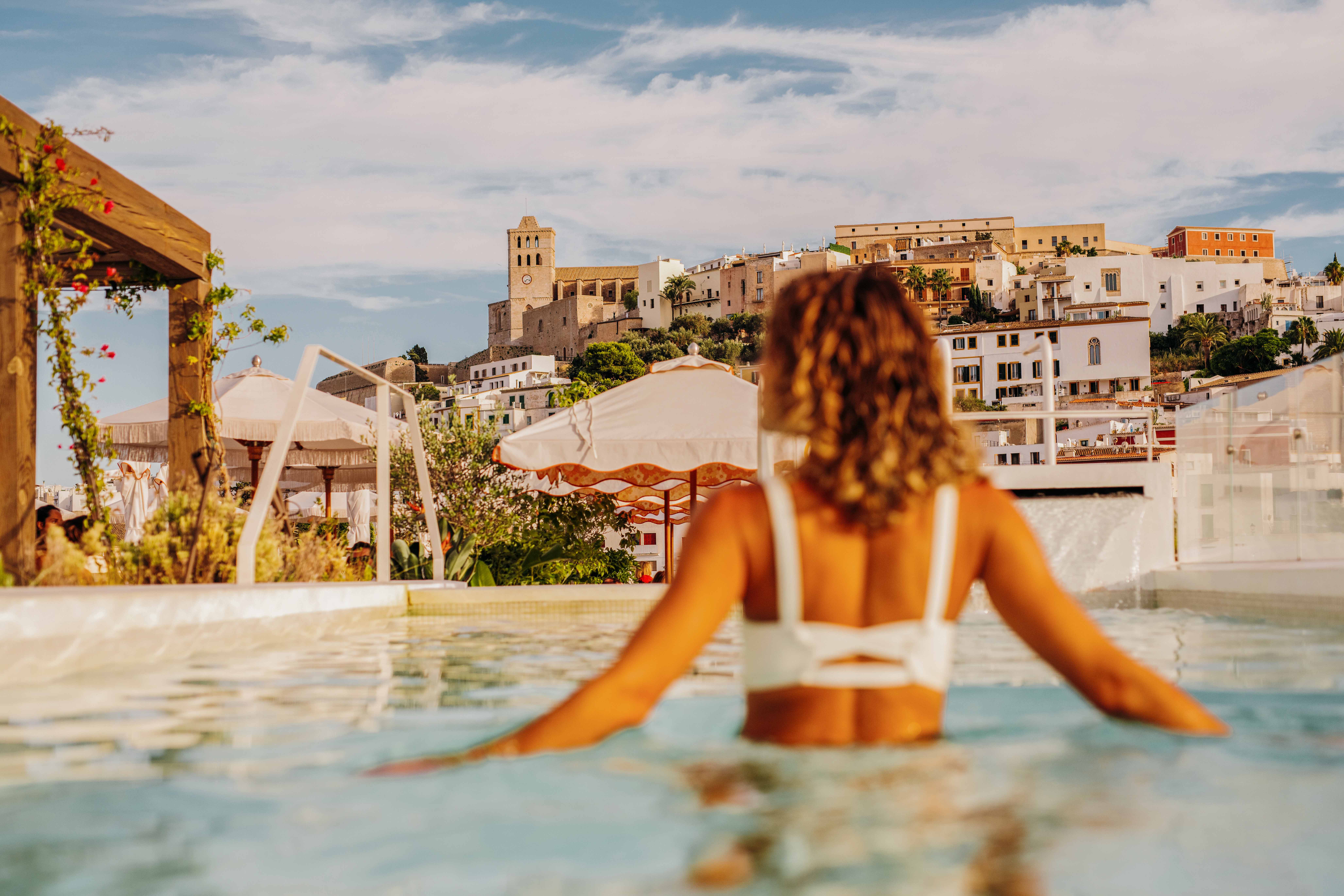A woman in a hotel swimming pool in Ibiza
