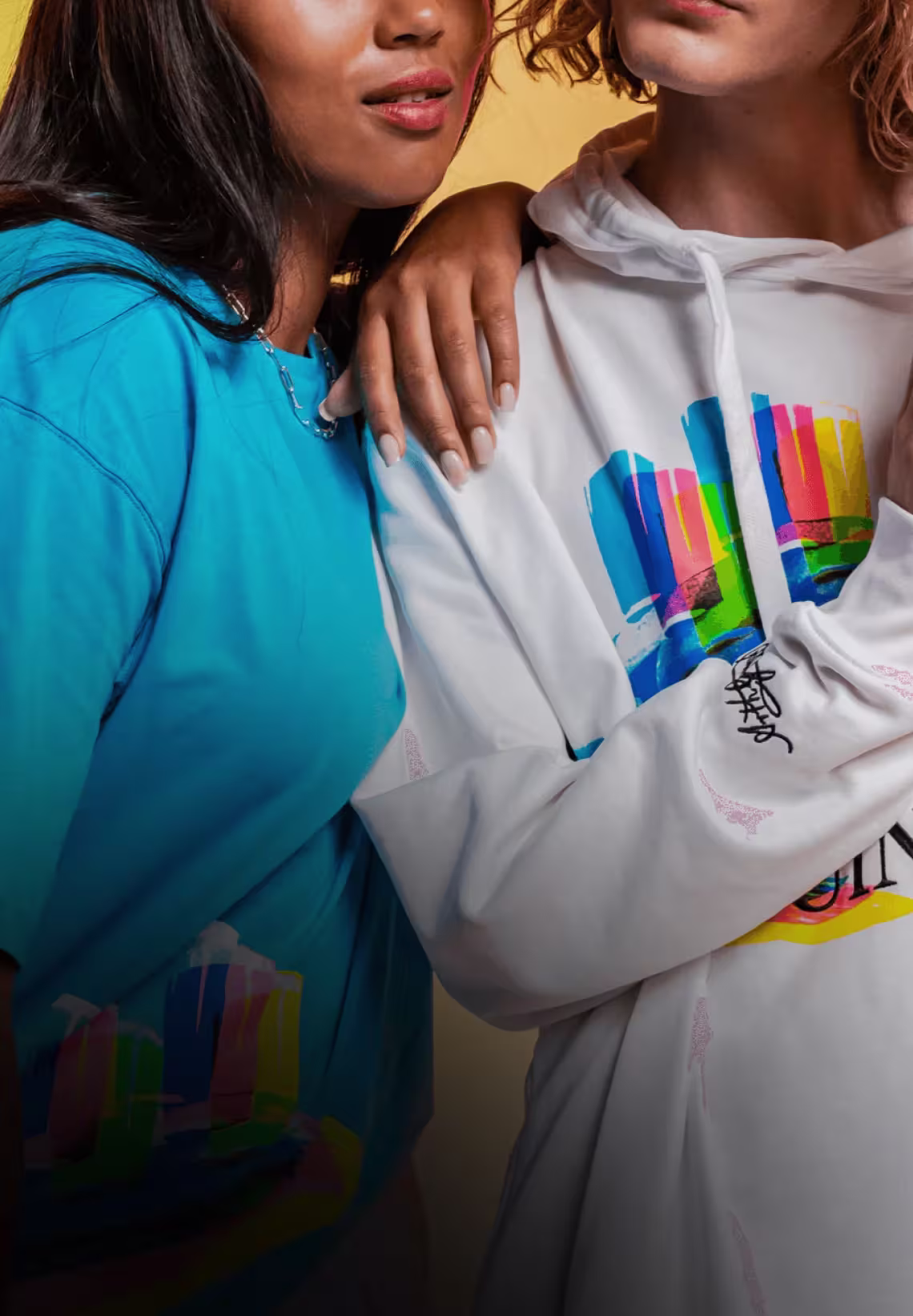 Two females wearing Guinness x Aches Collaboration merchandise.