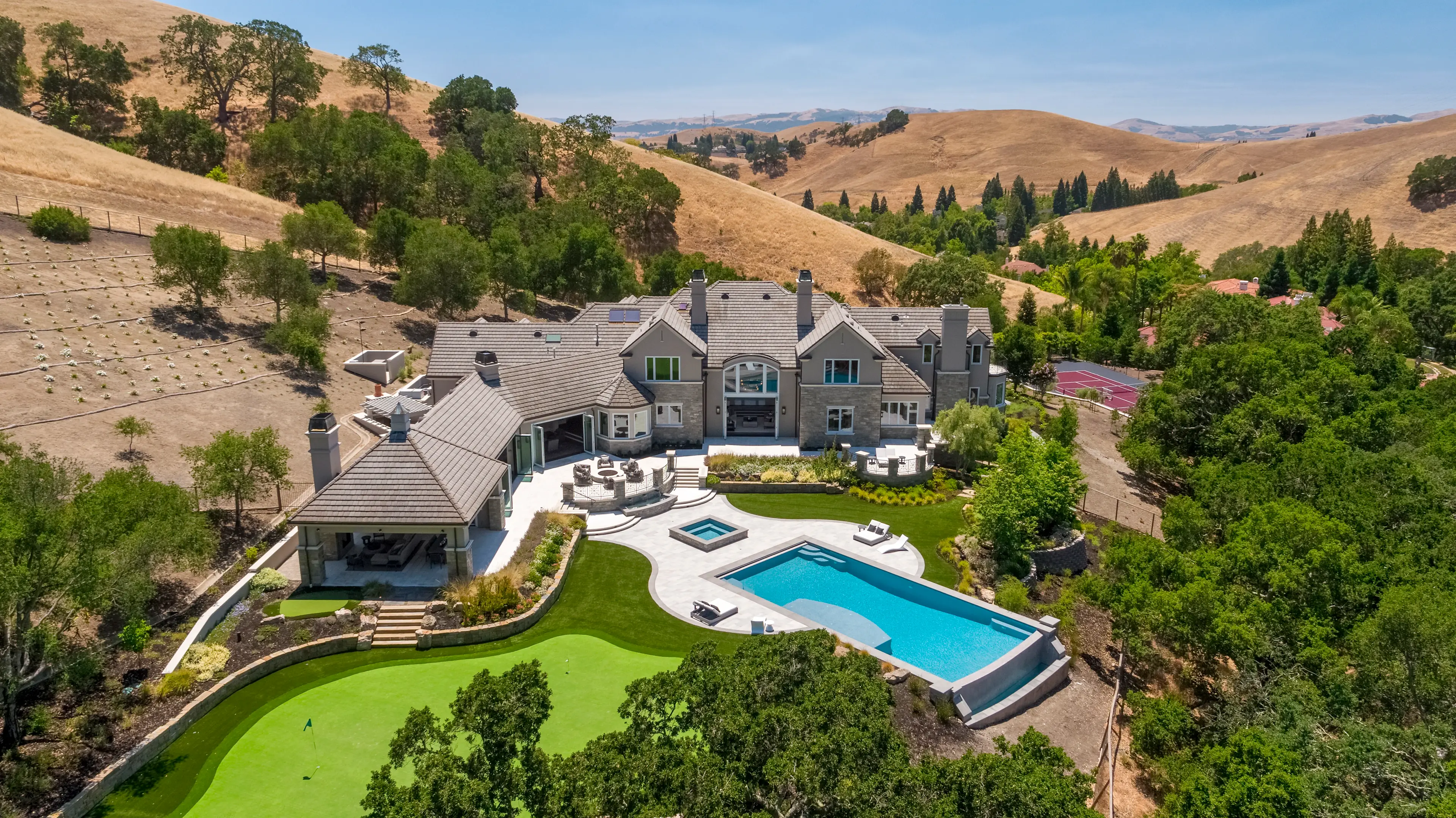 The crown jewel of the exclusive Blackhawk Country Club, this completely renovated home frames scenic views of Mt. Diablo from 5± acres, complete with a tennis & basketball court.