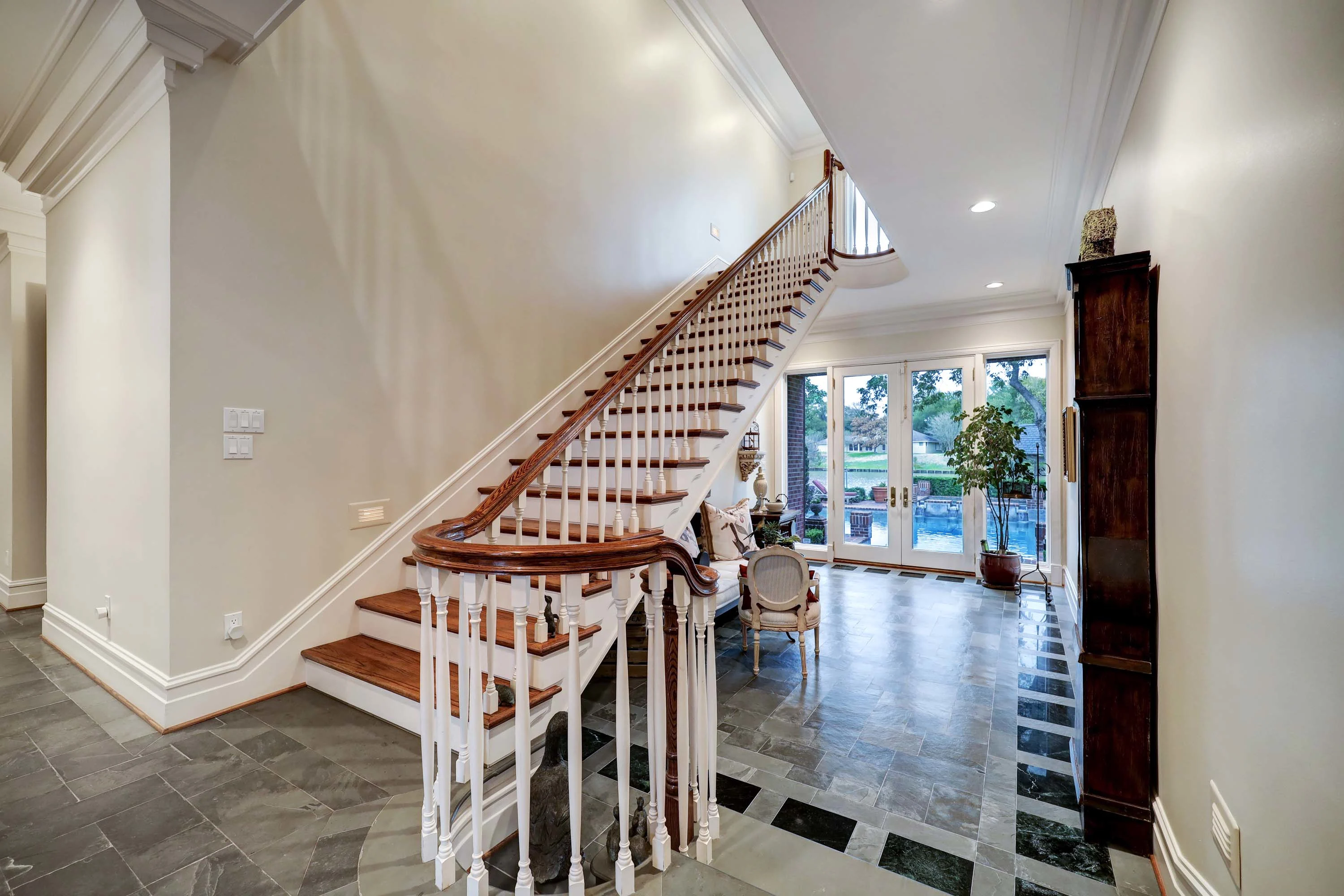 427 West Alkire Lake Drive, Sugar Land, Houston Area, Texas 77478 - 9_-_Alkire_Lake_W_427_IMG_016_1_1staircase_at_entry_with_sitting_are_and_door_that_leads_to_back_yard_dqlmxe