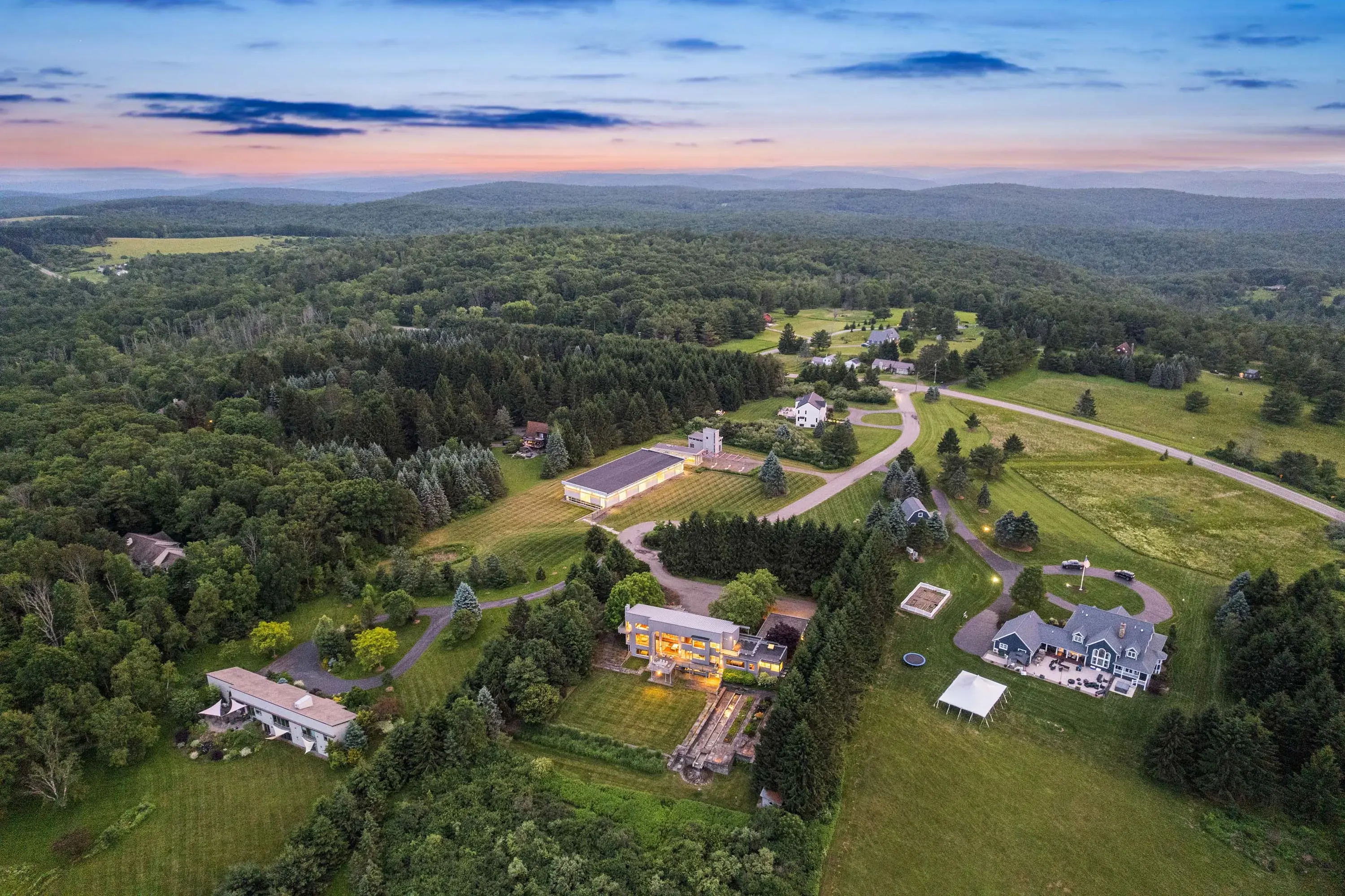 An architectural masterpiece awaits at this extraordinary Glass House and Tennis House compound designed by renowned architect George Hascup, founder of Hascup Architecture. This private sanctuary spans over four acres in prestigious Corning, featuring ne