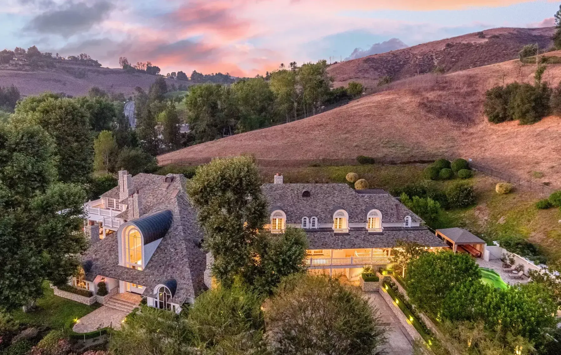 Nestled in the rolling hills of Westlake Village, this magnificent French-style estate in the exclusive Country Club Estates is the definition of charm and elegance. The interior features soaring, vaulted ceilings along with a two-story foyer with a chand