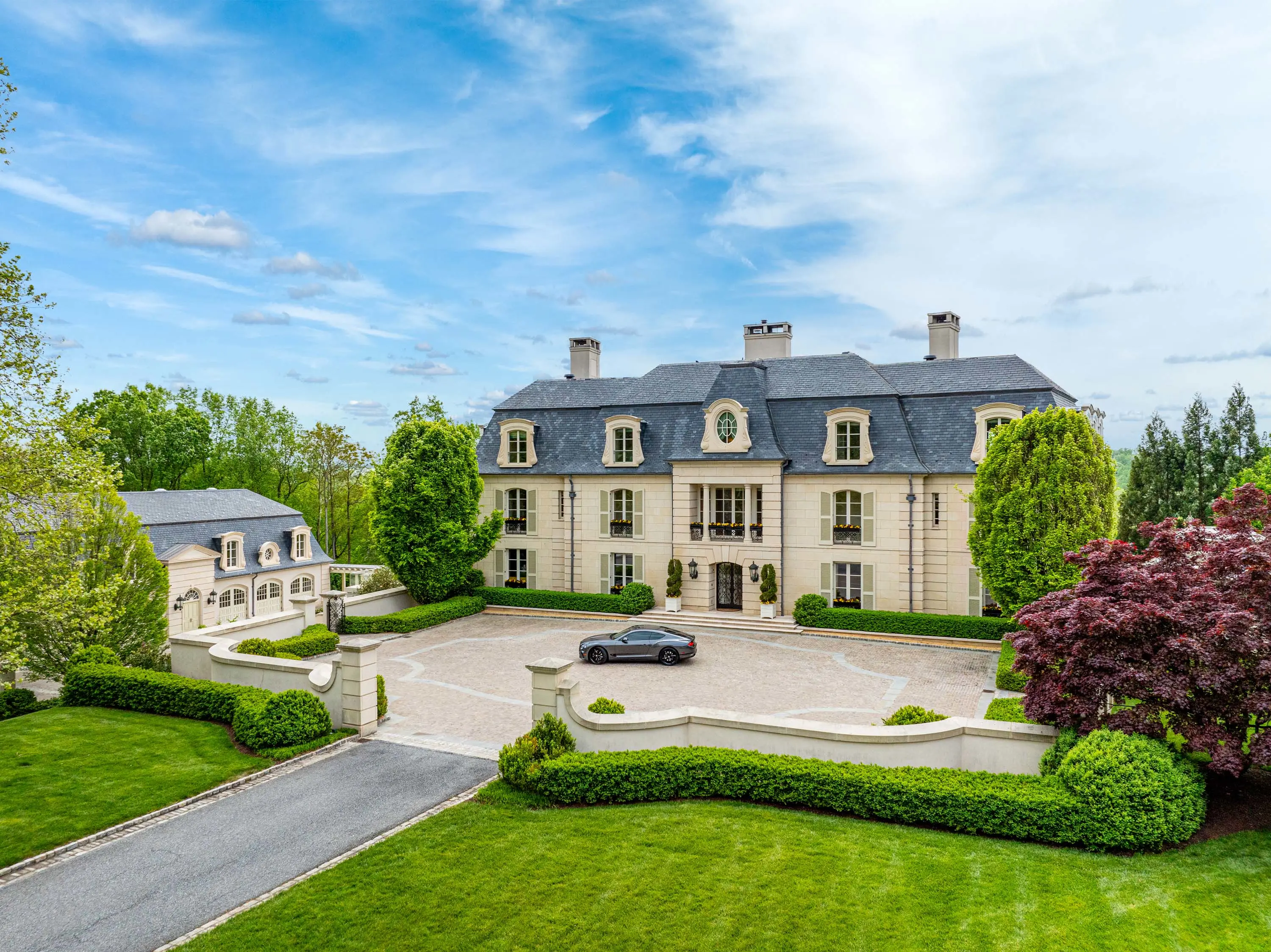 Anchored along the Potomac River on over 13 private acres, this magnificent French Chateau-inspired estate comprises over 40,000 square feet across three meticulously crafted structures.