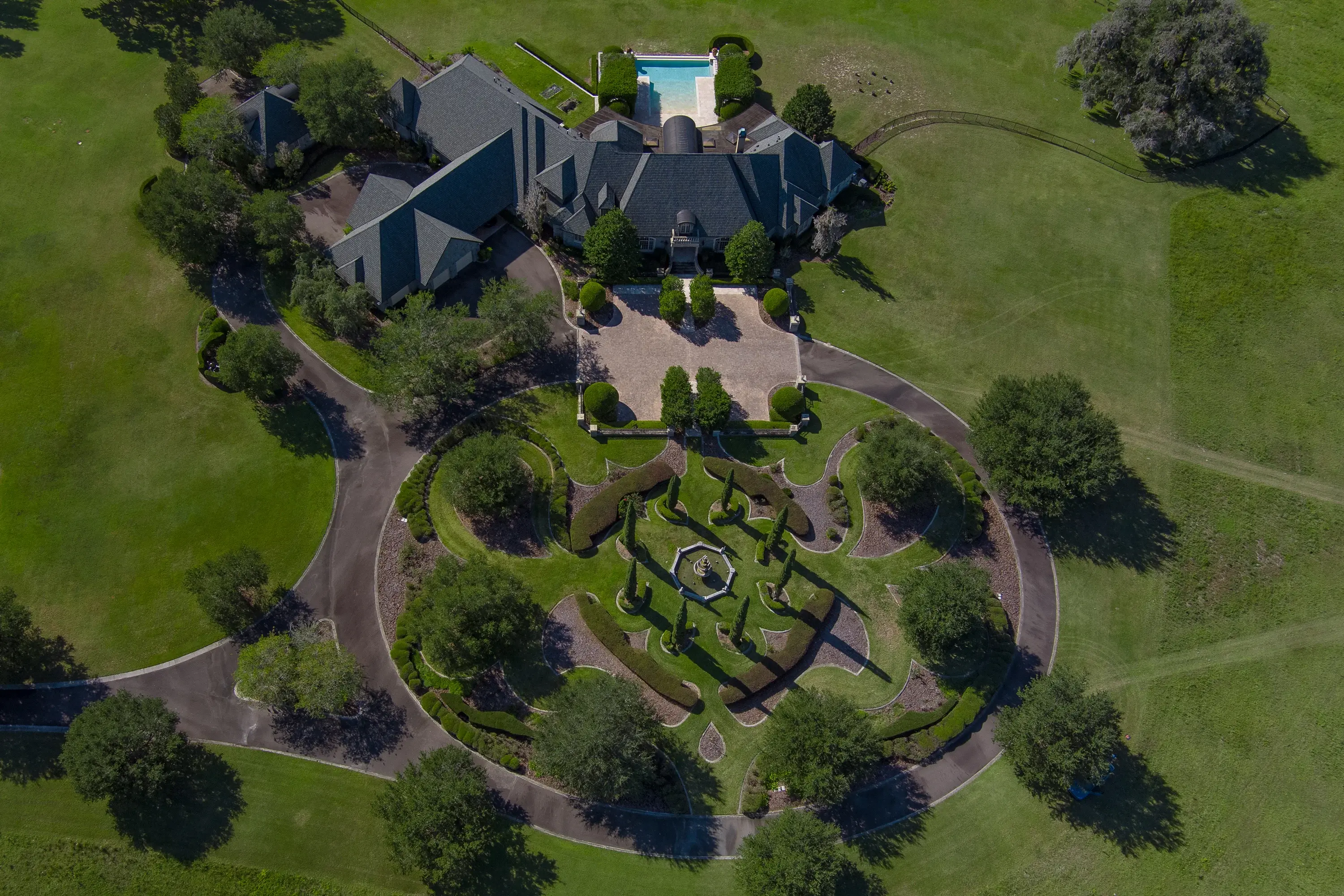 This spectacular 560+ acre hilltop estate features a French Provincial main residence, three-bedroom guest house, elegant five-bedroom duplex, and multiple staff apartments integrated within its equestrian facilities. 