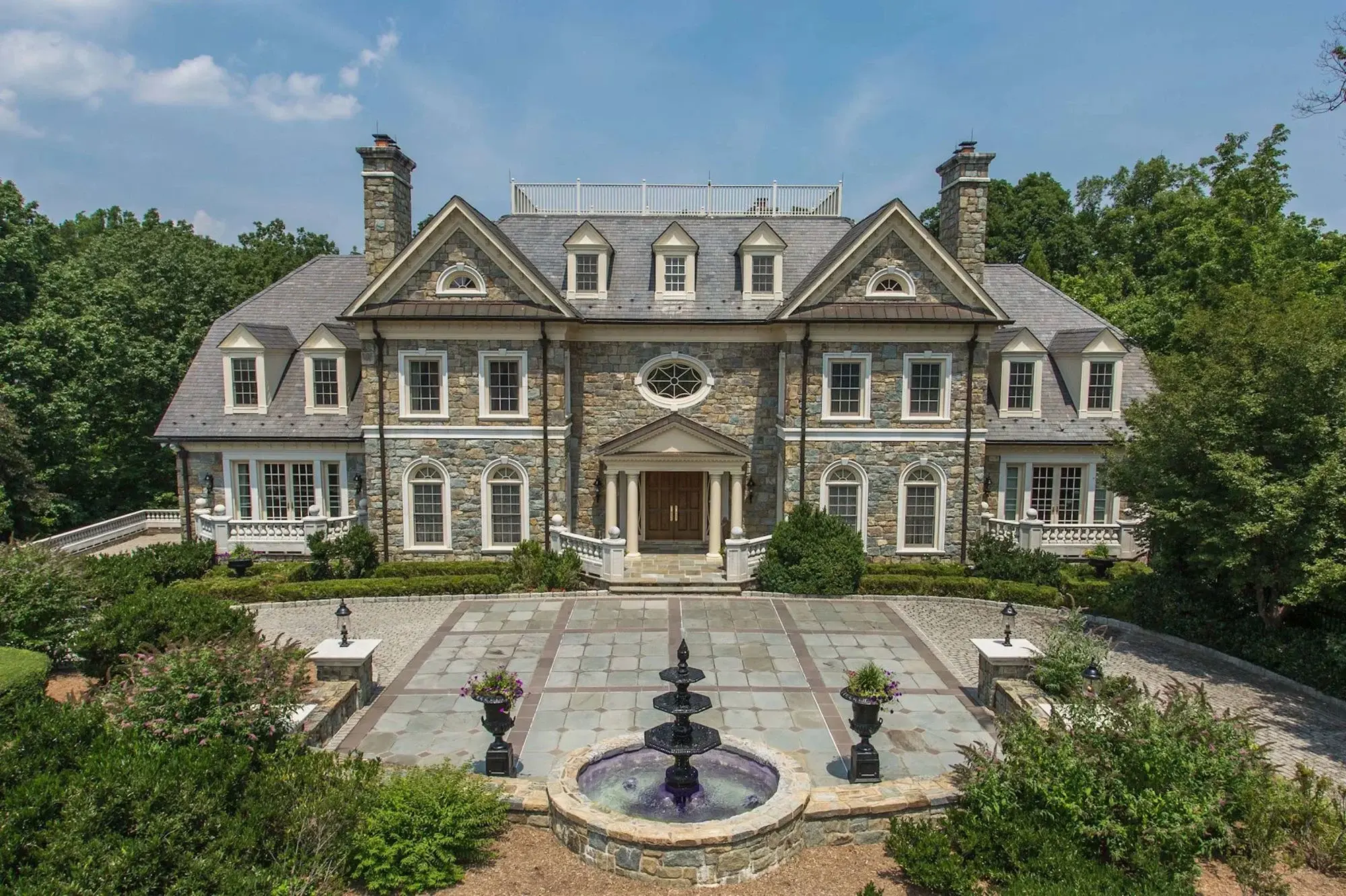 Immaculate estate with over five acres of forest, walking paths to a waterfall, and breathtaking luxury finishes. 