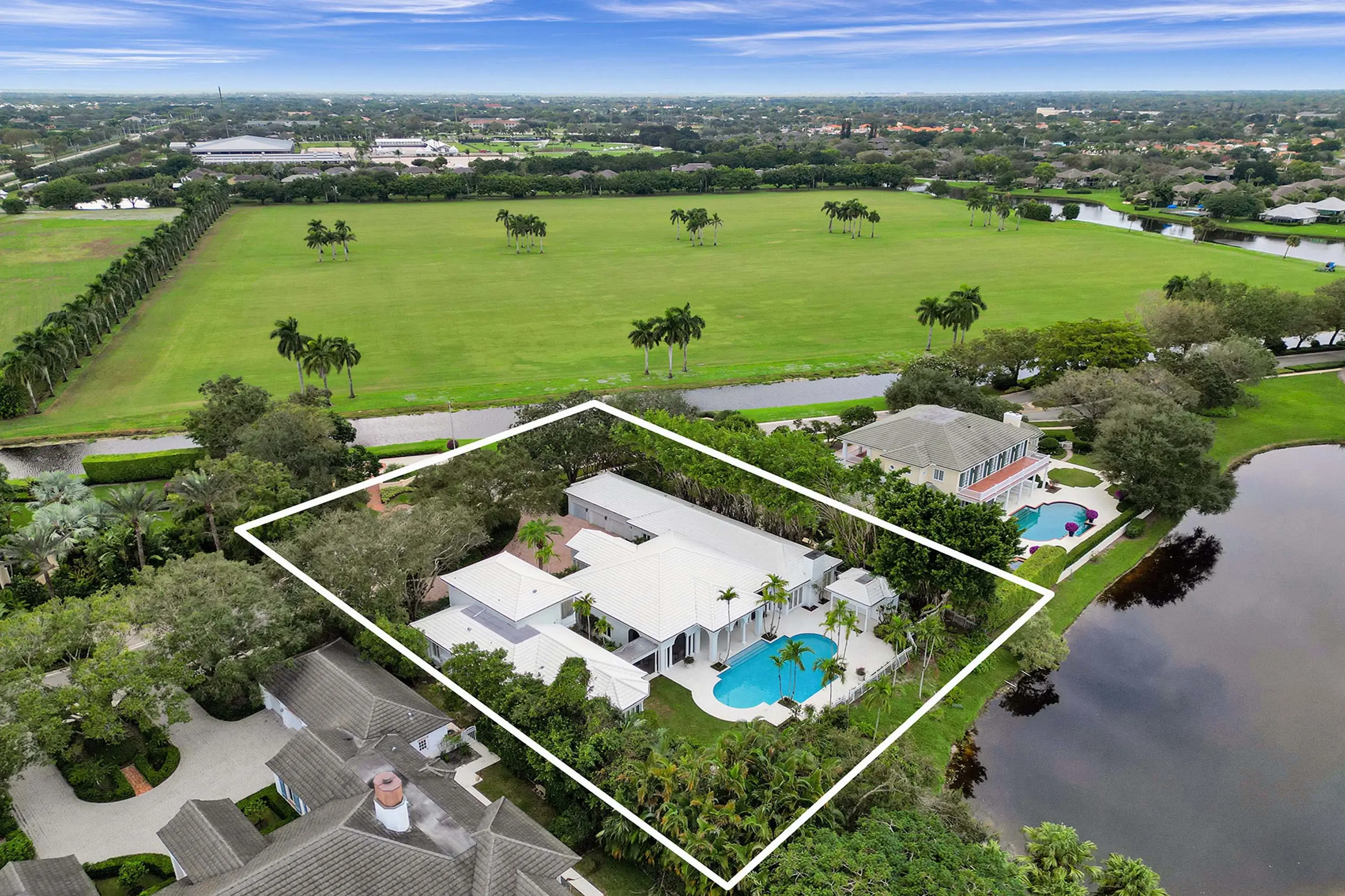 This Hurlingham Drive estate offers traditional luxury with outdoor amenities including a resort-style patio, swimming pool, and golf course views.