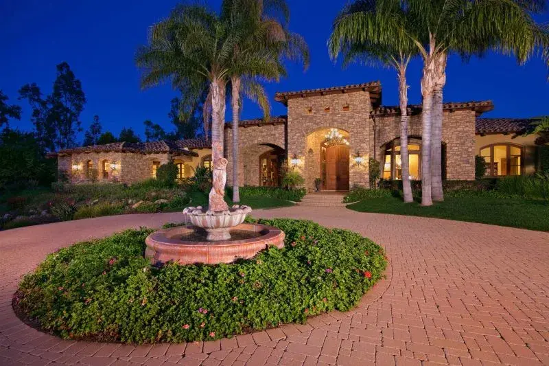 Situated atop an elevated two-acre lot in Rancho Santa Fe, this custom European-inspired estate with elegant Tuscan features offers privacy and boundless amenities. Located behind the gates of Fairbanks Ranch, the property is tucked on a quiet side street