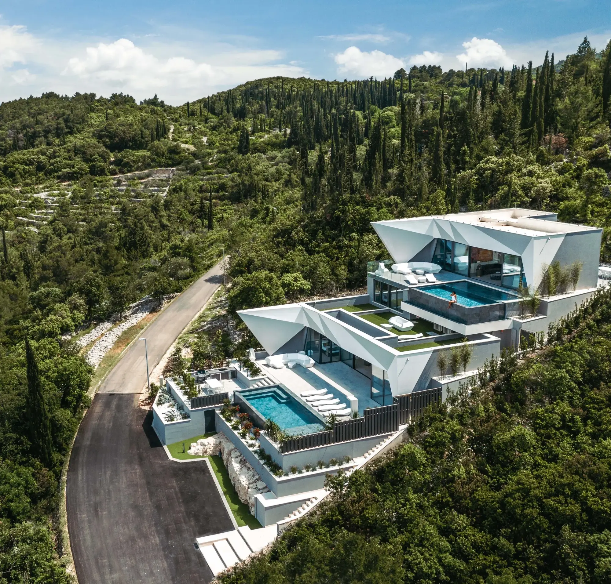 This stunning architectural masterpiece situated among rolling hills on the Dalmatian Coast offers Adriatic Sea views, two infinity pools, and incredible rental potential.