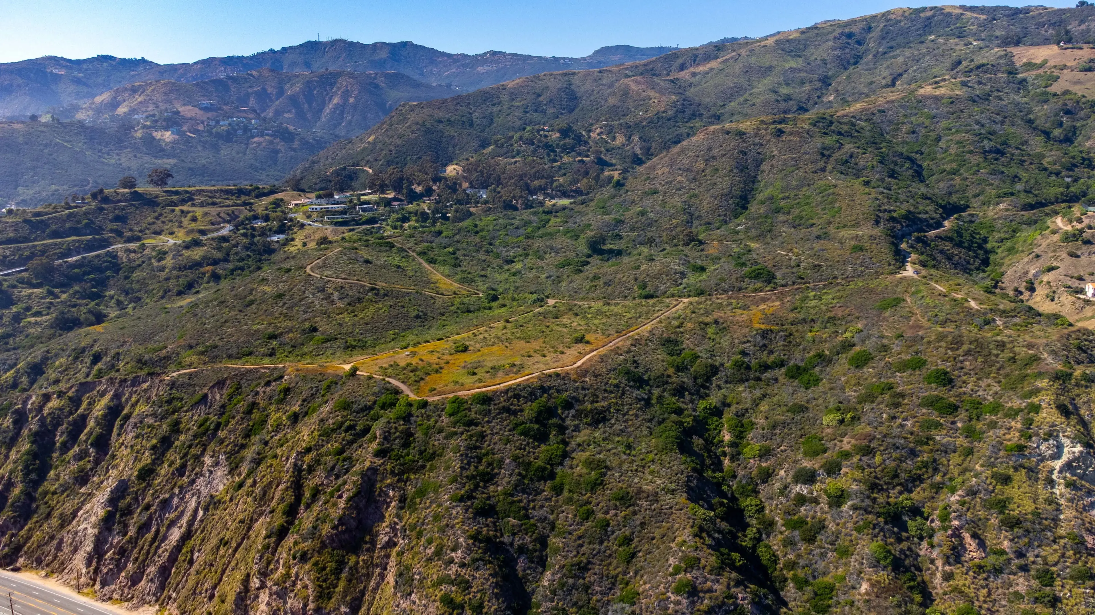32+ Malibu acres with panoramic ocean views, city lights, and mountain ranges, offering total privacy and tranquility.