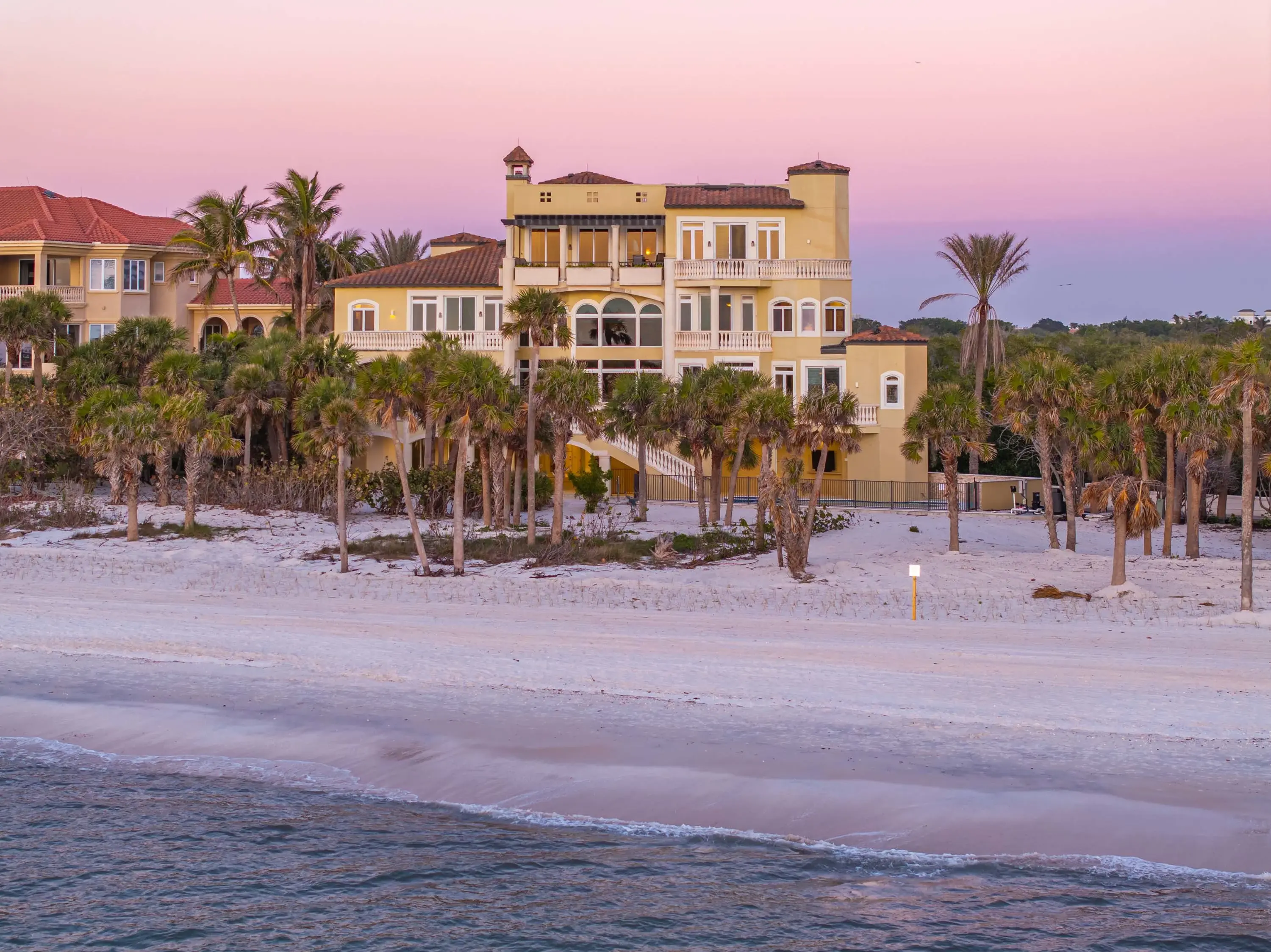 Experience unparalleled coastal luxury at 7425 Bay Colony Drive, an exclusive beachfront residence within the double-gated Strand at the Colony of Pelican Bay. As one of only eleven homes in this prestigious enclave, it offers over 9,000 square feet of re