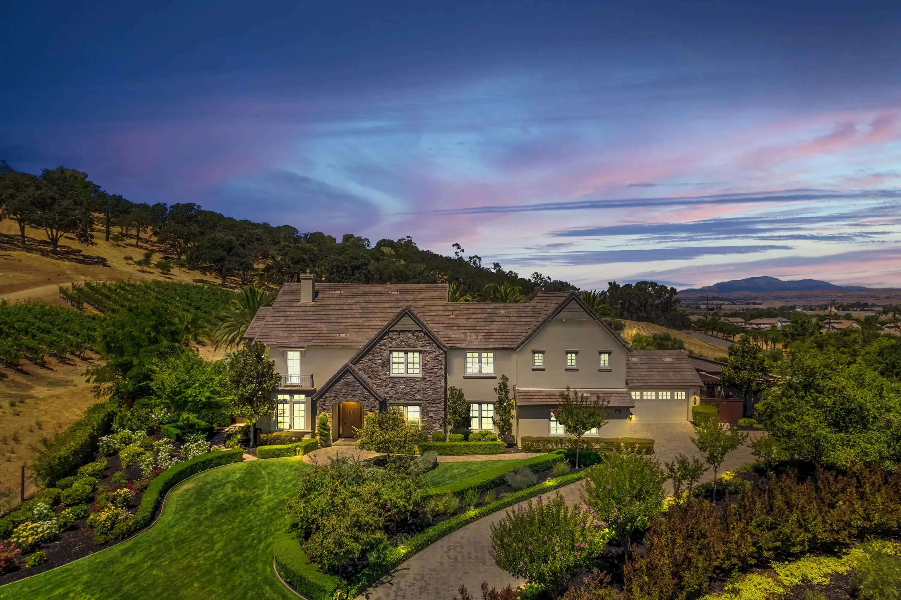 This award-winning vineyard estate sits on 14-acres with a grand entrance and a backyard oasis surrounded by vineyards and rolling hills, offering total privacy.