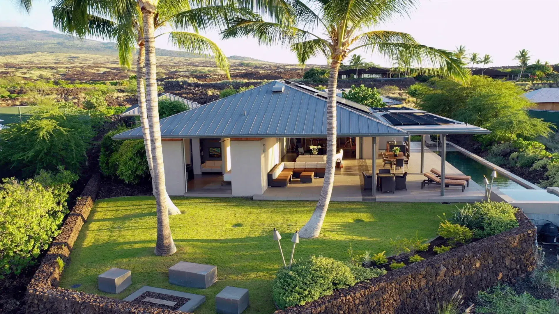 E Komo Mai, (welcome) – paradise beckons in Kuki'o. This contemporary estate, surrounded by lush landscaping and island views, is an ideal oasis for your al fresco lifestyle. Telescoping walls of glass open up entirely to the incredible outdoor kitchen, l