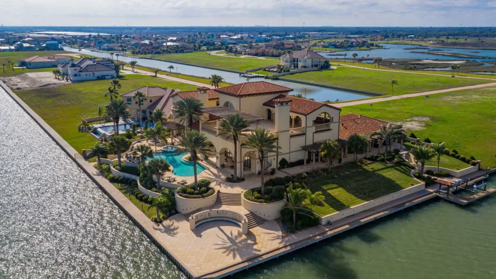 This sprawling turnkey/furnished Mediterranean-style villa is the perfect coastal retreat to host gatherings with a private boat dock.