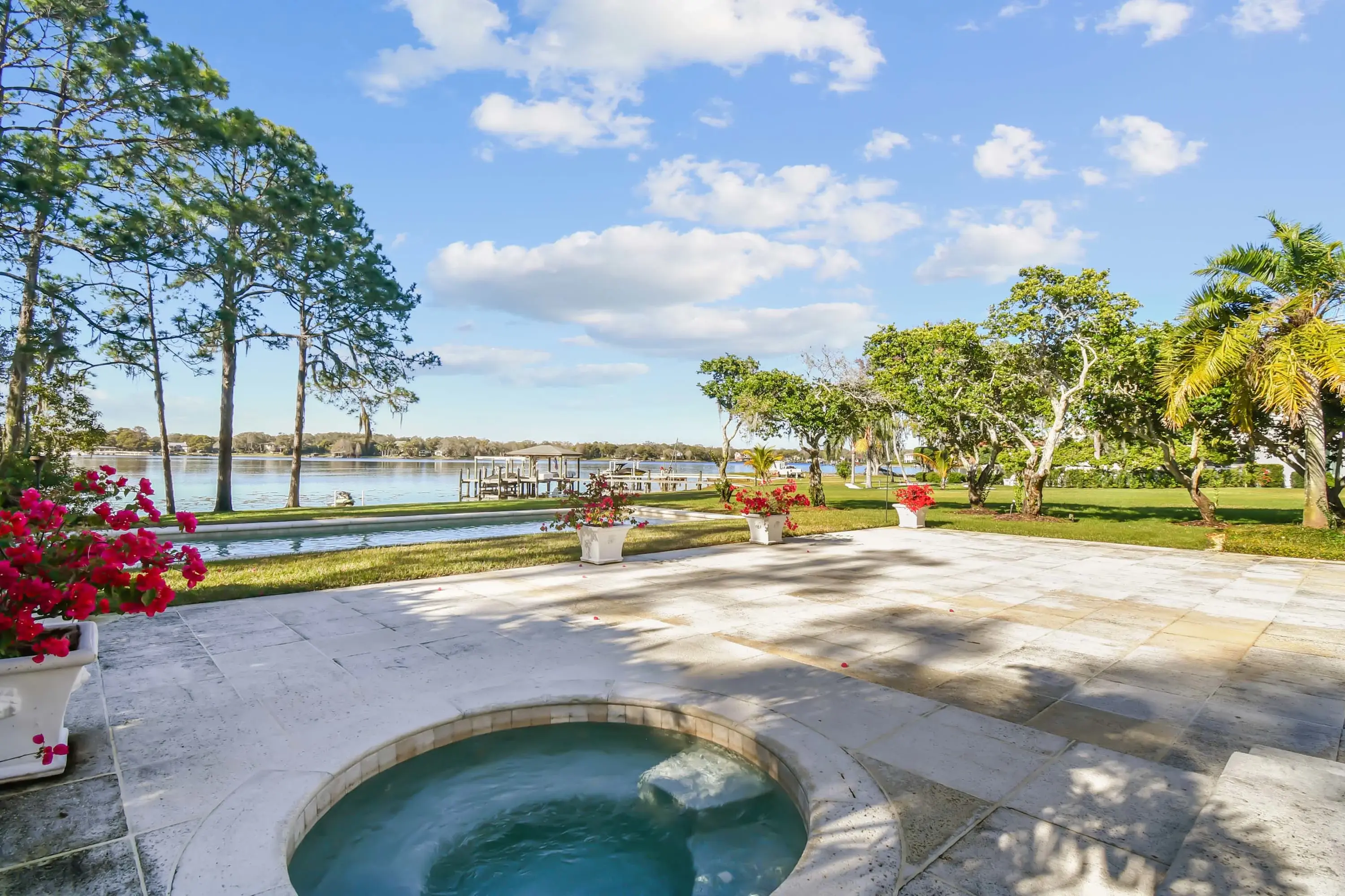 This stunning Lake Carroll property is a private paradise in the only gated community on the lake. Step through the grand arched front door and into the bright great room with luxurious marble floors. The chef’s kitchen boasts new LG Studio appliances, a 
