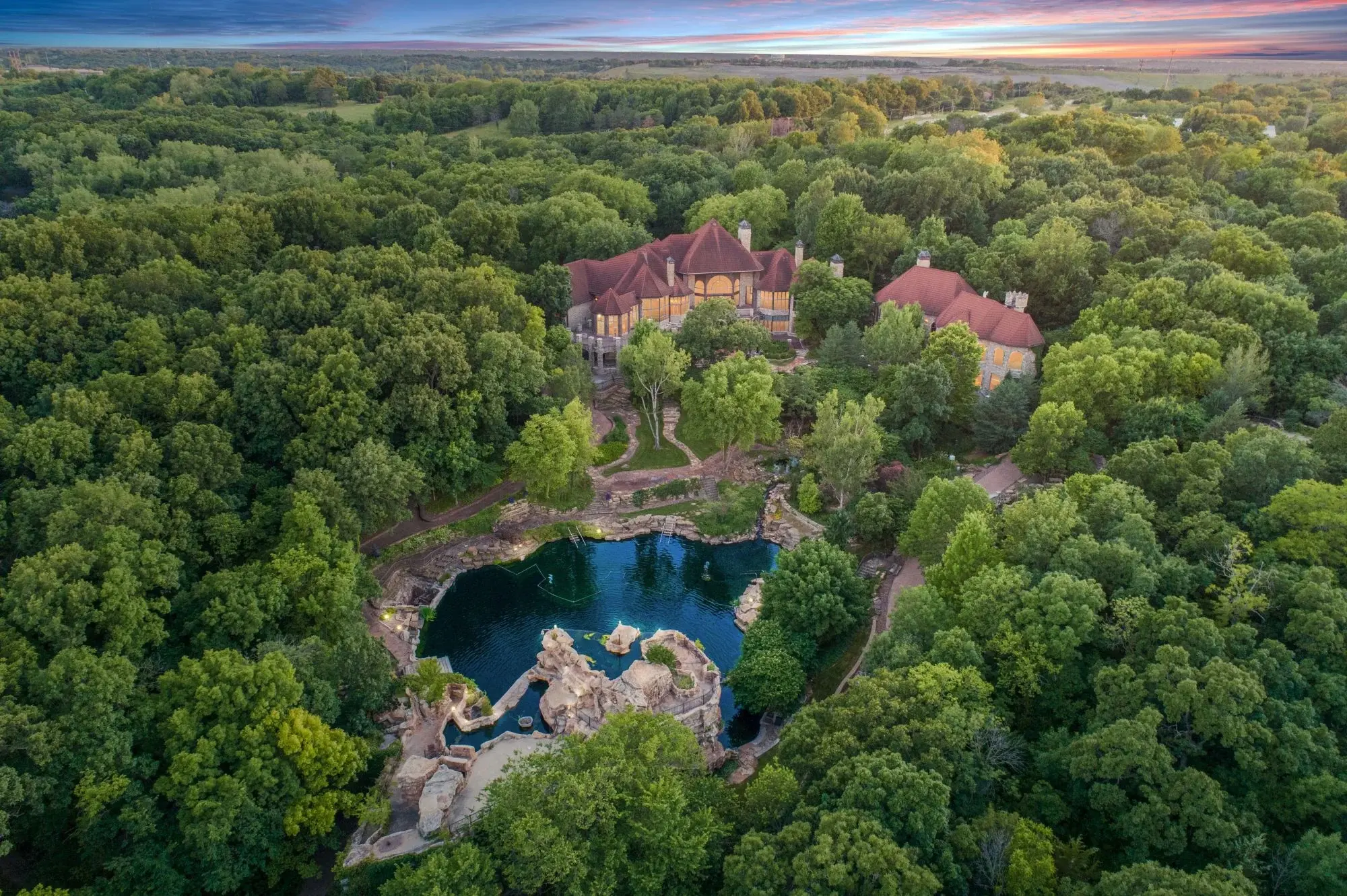 Set atop a rare 15± acres, this immaculate 17,700±-square-foot estate boasts a grotto and pool with a 35-foot waterfall, luxurious European-inspired details, and proximity to the exclusive Lake Quivira Country Club community.