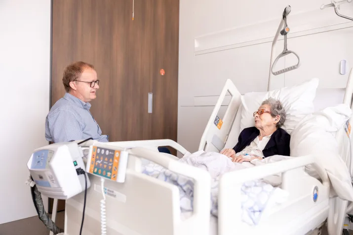 Agent d'accompagnement spirituel et patient dans une chambre au campus de Rumbeke