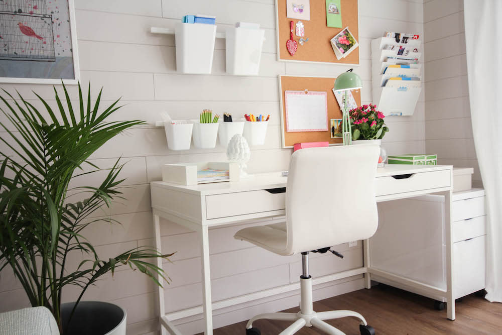 white office with modular wall storage and white desk