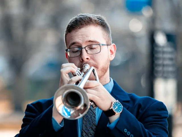 A shot of Robbie playing trumpet