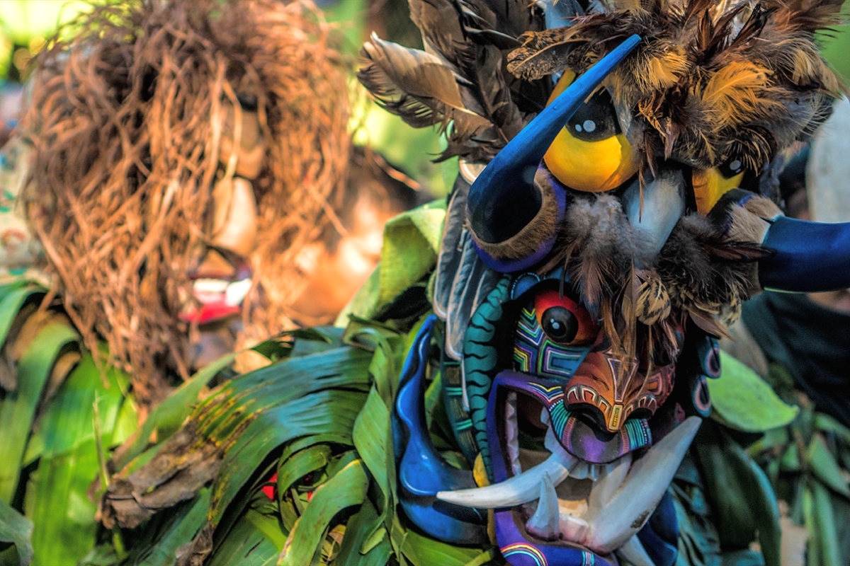 Masked dancers dancing Lucha de los Diablitos, Boruca traditional performance in Costa Rica