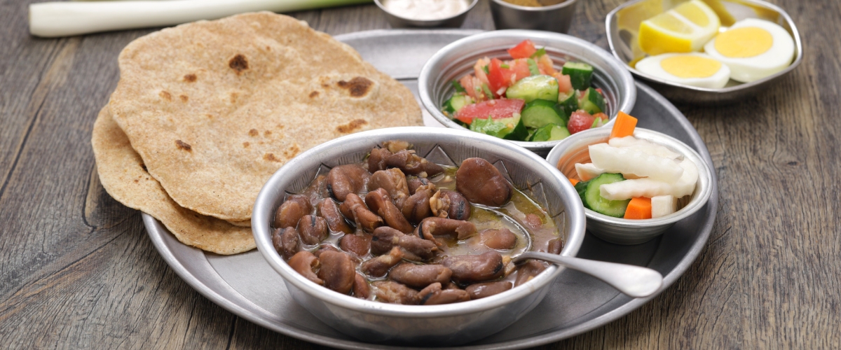 Ful Medames Egyptian cuisine, breakfast with bread, vegetables, and eggs