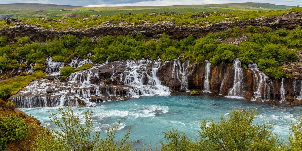 Hraunfossar waterfall cascades into Hvita River in Husafell, Western Iceland