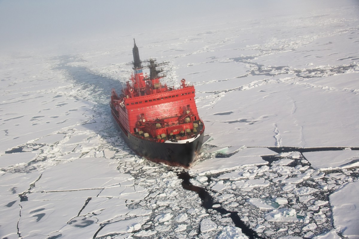Red nuclear ice breaker ship in the Arctic iceberg water heading to the North Pole