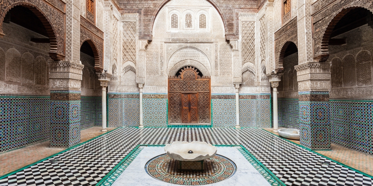 Al-Attarine Madrasa courtyard of intricate tilework in Fes, Morocco